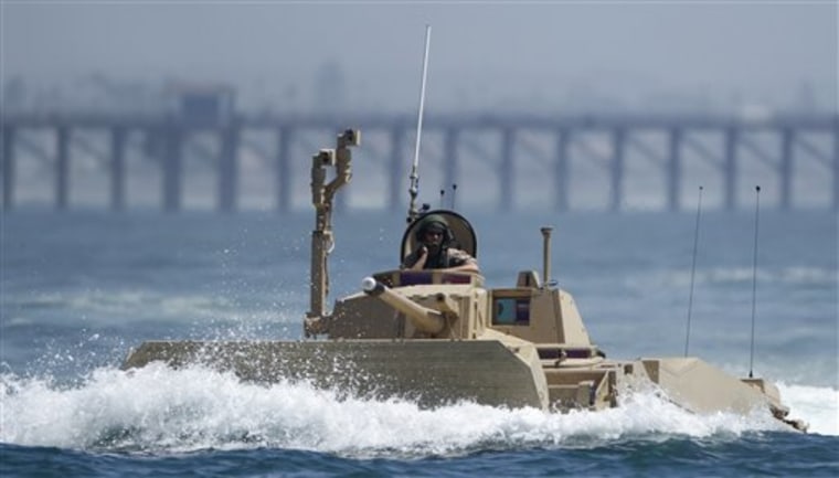 FILE - In this Aug. 24, 2010, file photo, a prototype of a Marine Expeditionary Fighting Vehicle runs a test in the waters off the coast of Oceanside, Calif. Defense Sec. Robert Gates was expected to announce on Thursday, Jan. 6, 2010, that he would cancel a $13 billion plan to buy the Marines amphibious assault vehicles from General Dynamics Corp., in the latest rounds of cost-cutting measures for the military.  (AP Photo/Gregory Bull)